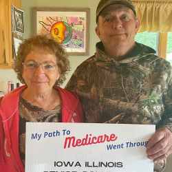 senior couple holding medicare sign