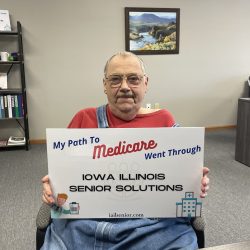 senior holding medicare sign